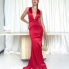red formal gown with plunging neckline, adjustable straps and figure hugging mermaid skirt