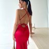 red formal gown with plunging neckline, adjustable straps and figure hugging mermaid skirt