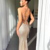 back view of copper formal gown with stylish straight neckline, thin straps, lace-up back and full sweeping train