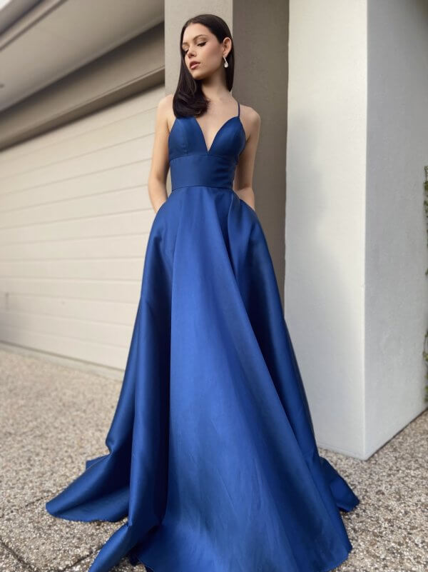 blue formal gown with pockets, deep neckline, and full skirt