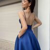 blue formal gown with pockets, deep neckline, and full skirt