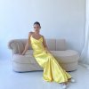 yellow formal gown with cowl neckline, and cowl backline, slim straps and a flattering mermaid-like silhouette