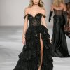 Tulle sequin A-Line gown with sheer corset bodice, off the shoulder straps and ruffle high slit skirt.