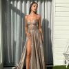 copper glitter formal gown with deep v neck illusion, high side slit, and spaghetti strap