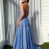 blue glitter formal gown with deep v neck illusion, high side slit, lace up back, and spaghetti strap