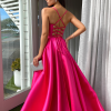 fuchsia formal gown with deep v neck illusion, high side slit, lace up back, and spaghetti strap