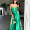 emerald formal gown with deep v neck illusion, high side slit, lace up back, and spaghetti strap