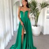 emerald formal gown with deep v neck illusion, high side slit, lace up back, and spaghetti strap