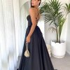 black formal gown with deep v neck illusion, high side slit, lace up back, and spaghetti strap