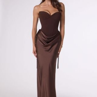 Model wearing the Espresso Remi Gown, a strapless satin formal dress featuring a structured corset bodice, draped hip detailing, lace-up back and fitted floor-length skirt.