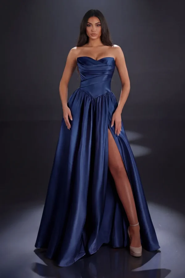 Clara Gown in Navy Mikado featuring a strapless sweetheart neckline, draped bodice, drop waist, full A-line skirt and high leg split.