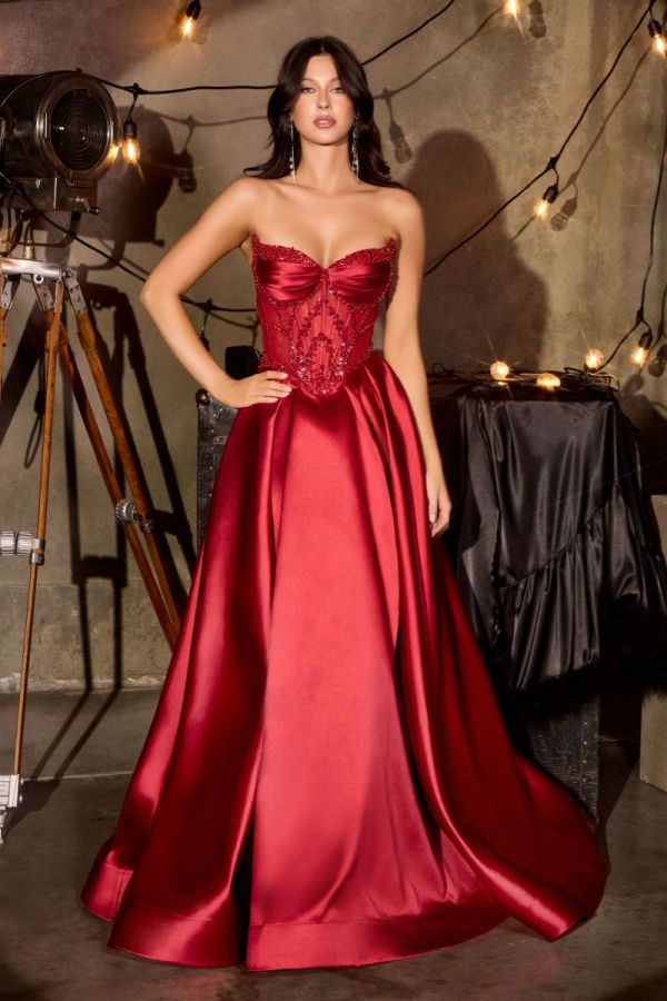 Violet Gown in burgundy mikado featuring a beaded sheer corset bodice, sweetheart neckline and full ballgown skirt.