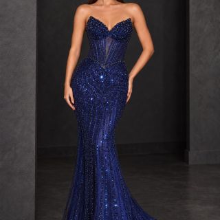 Coco Gown in Navy, featuring a strapless corset bodice, lace-up back, intricate beading and a fitted skirt with a sweeping train, shown from the back.